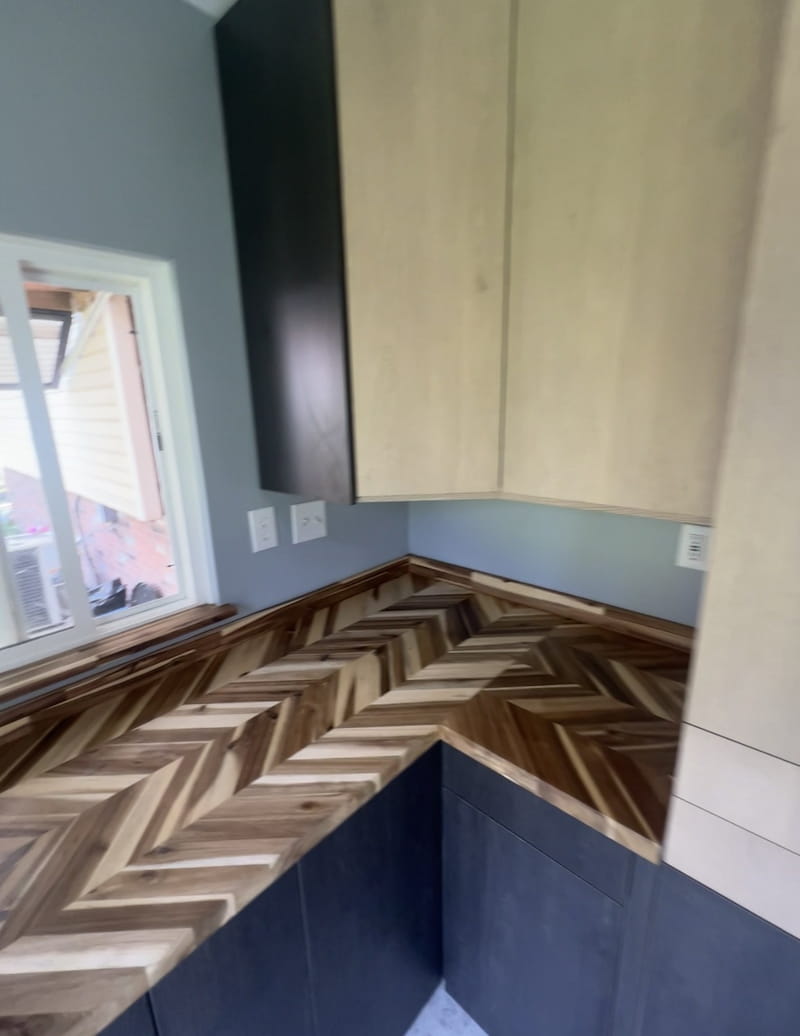 Close-up of custom herringbone wood countertop corner detail